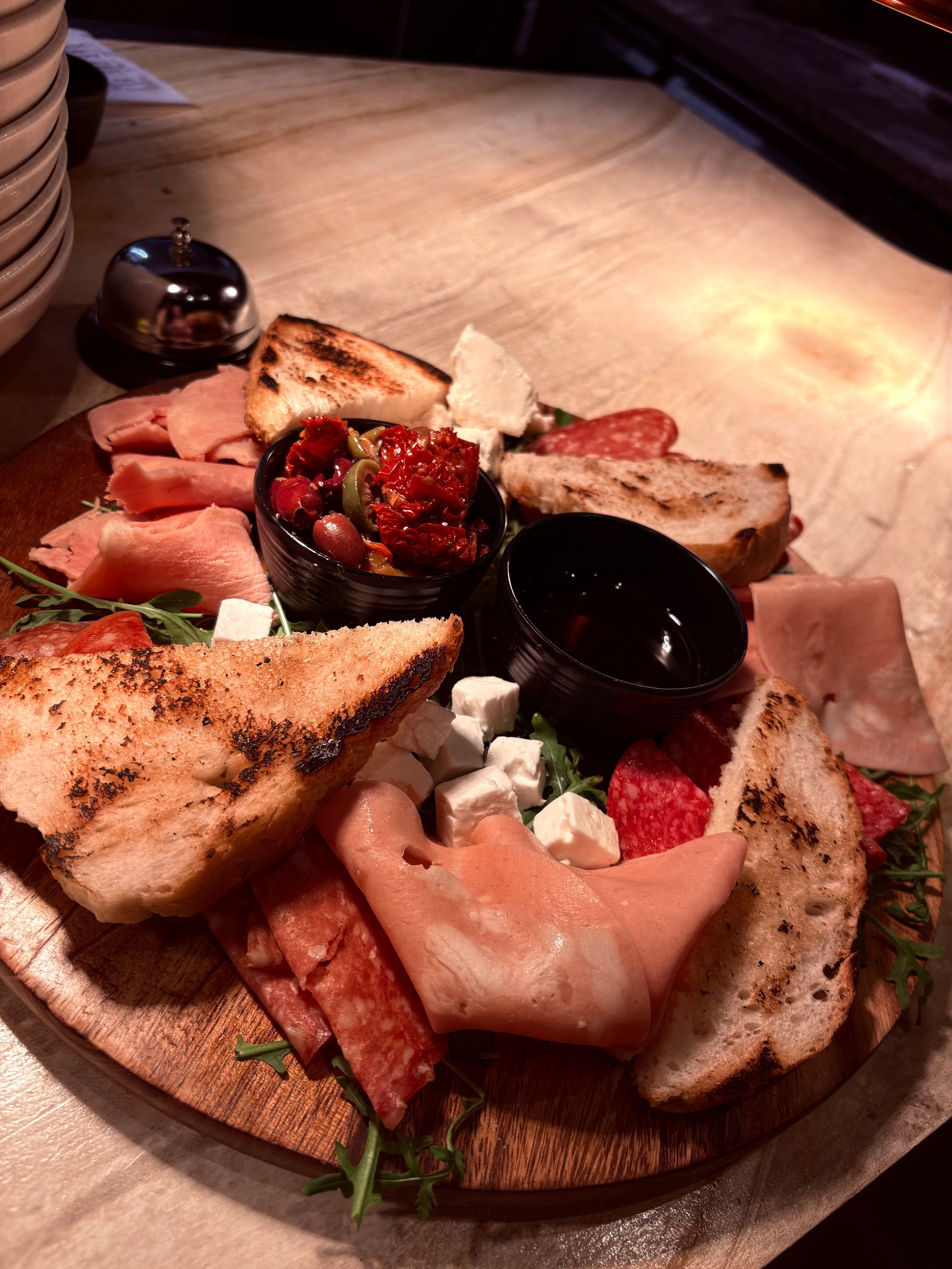 Mediterranean charcuterie board with cured meats, cheeses, and grilled bread